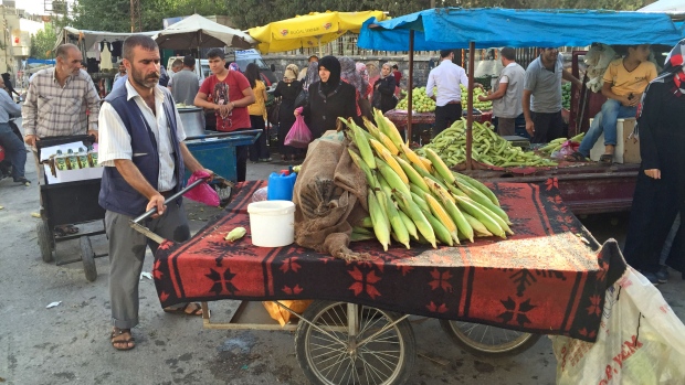 Many Syrian refugees have found work such as this produce vendor across the border in Turkey and don't want to uproot to Europe. Others are sticking around because they hope to return to their nearby homes once the Syrian civil war ends