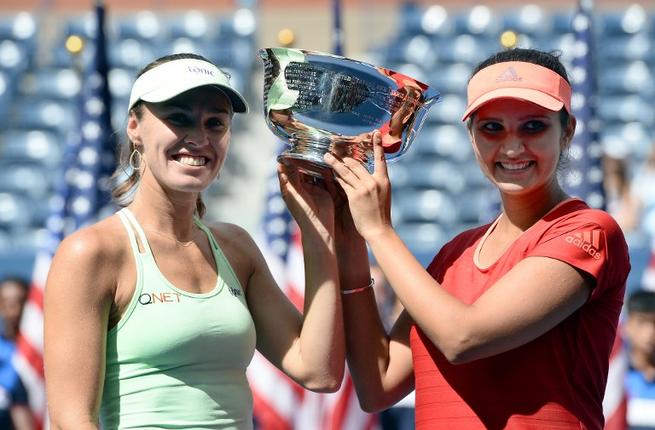 Mirza of India and her teammate Hingis of Switzerland celebrate with their trophy after defeating Dellacqua of Australia and Shvedova of Kazakhstan during their 2015 US Open Women's Double final