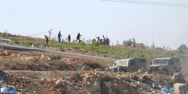 Palestinian rioters throwing rocks and firebombs across from Beit El on the old Route 60