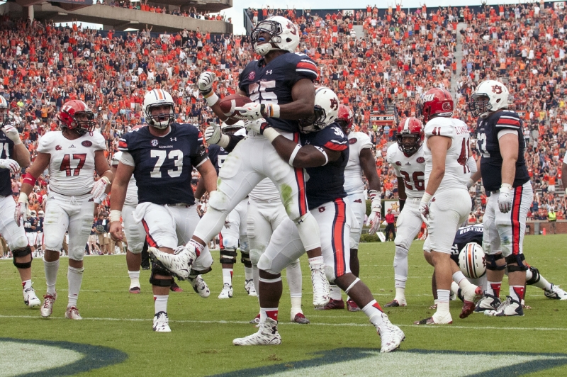 Peyton Barber is lifted by a teammate after scoring the game winning touchdown in overtime. Jacksonville State vs Auburn on Saturday Sept. 12