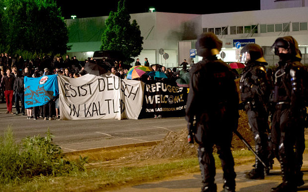 Police faces far-right activists protesting the opening of a new centre for refugees