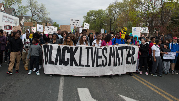 Protesters demonstrate at a Black Lives Matter rally. Fibonnaci Blue  Flickr