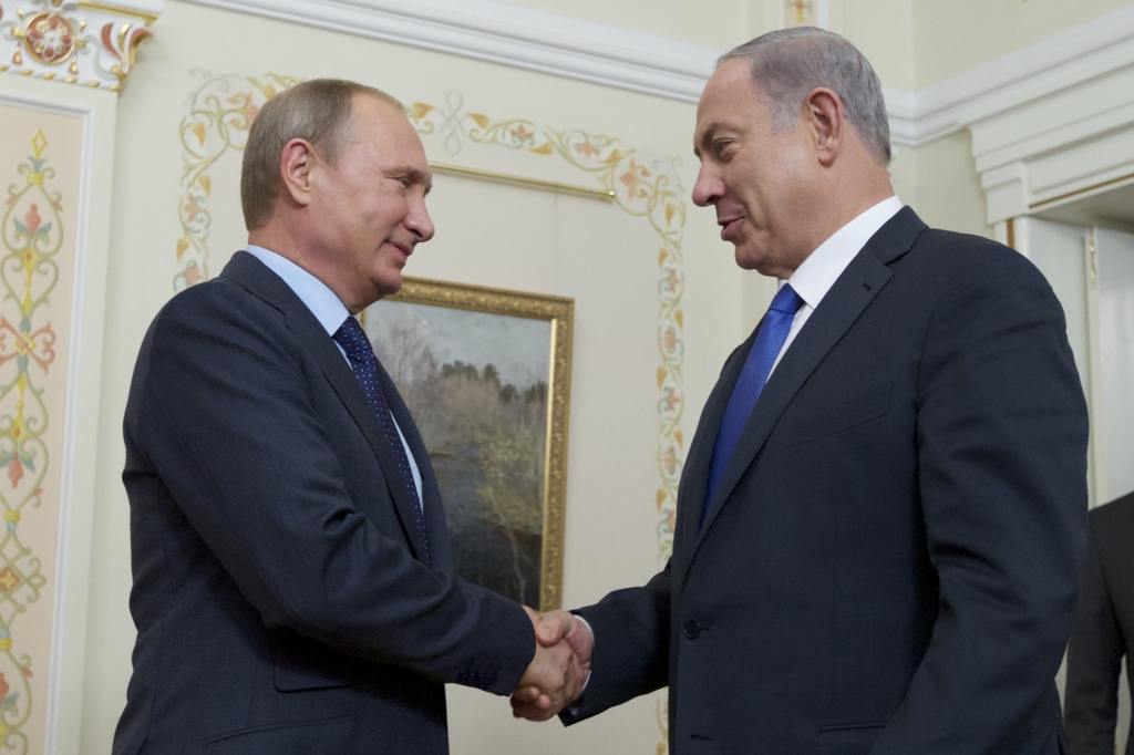 Russian President Vladimir Putin shakes hands with Israeli Prime Minister Benjamin Netanyahu right during their meeting in the Novo Ogaryovo residence outside Moscow Russia