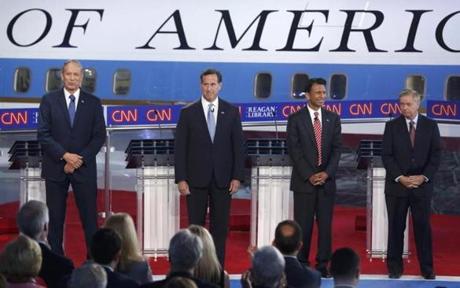 Republican US presidential candidates George Pataki Rick Santorum Bobby Jindal and Lindsey Graham gathered onstage