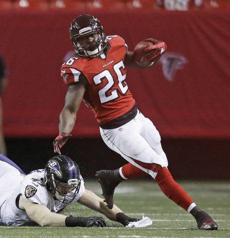 Atlanta Falcons running back Tevin Coleman Baltimore Ravens linebacker Brennen Beyer during the first half of an NFL football preseason game Thursday Sept. 3 2015 in Atlanta