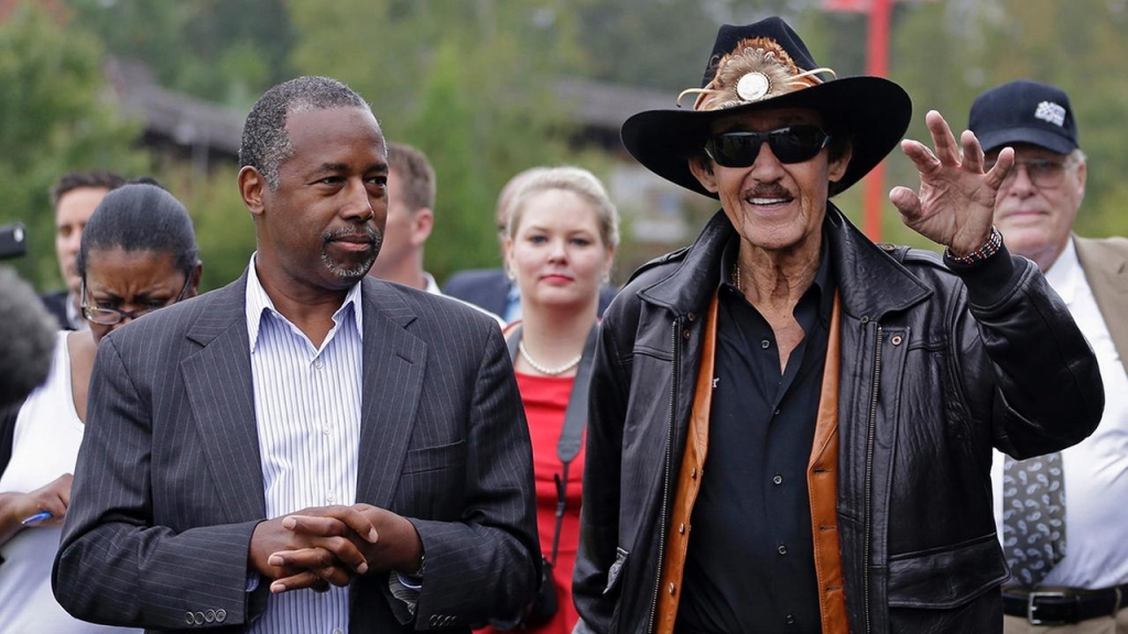 Republican presidential candidate retired neurosurgeon Ben Carson listens to NASCAR legend Richard Petty during a tour of the Victory Junction Gang Camp in Randleman N.C