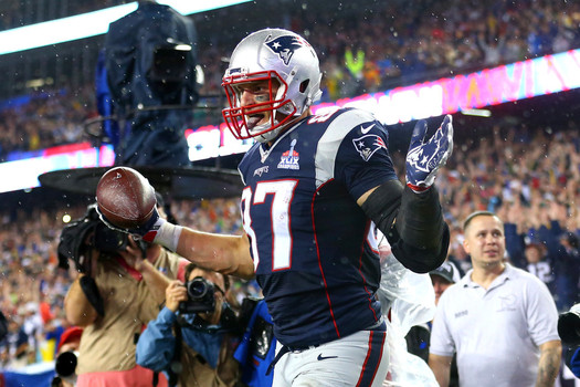 Rob Gronkowski #87 of the New England Patriots celebrates after scoring his third touchdown of the game in the fourth quarter against the Pittsburgh Steelers at Gillette Stadium