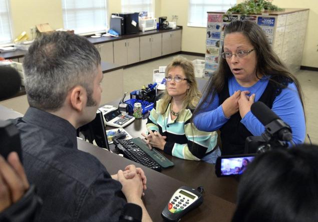 Rowan County Ky. Clerk Kim Davis explains her refusal to grant marriage licenses over her objections to gay marriage. The woman who sits next to her in the office told a newspaper she wasn't amused by a Twitter account purporting to represent her