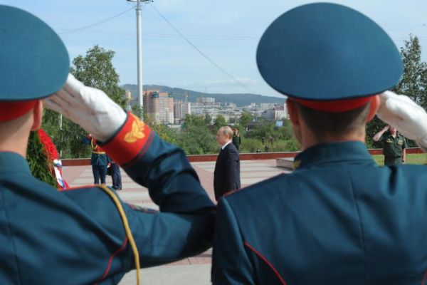 Russian President Vladimir Putin background stands during