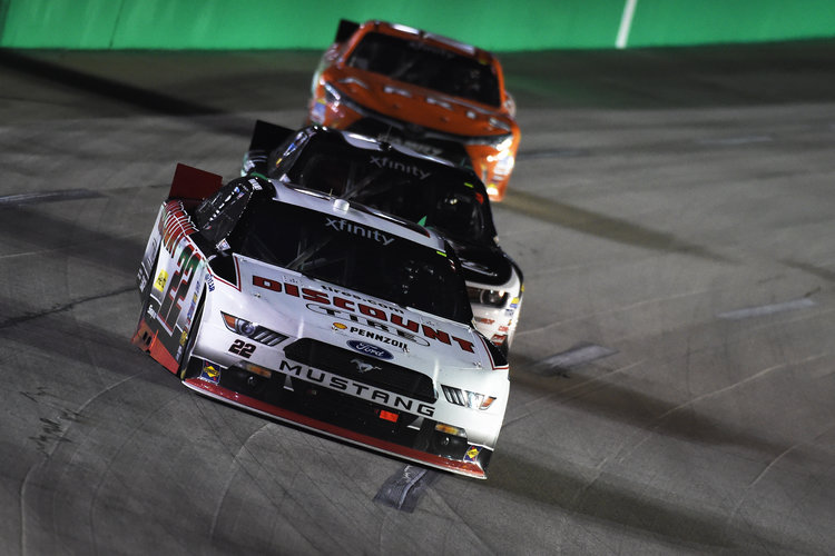 SPARTA KY- SEPTEMBER 26 Ryan Blaney driver of the #22 Discount Tire Ford leads Brian Scott driver of the #2 Shore Lodge Chevrolet and Daniel Suarez driver of the #18 ARRIS Toyota during the NASCAR Xfinity Series