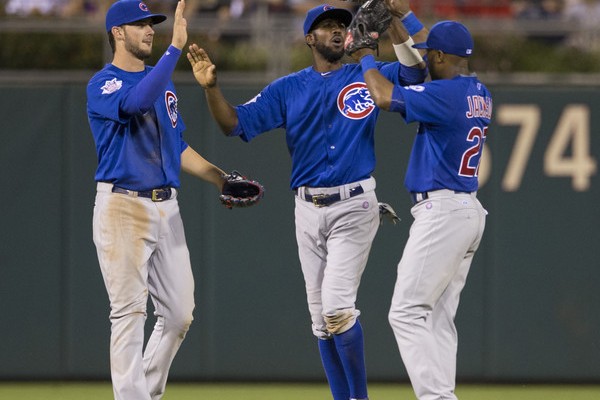 Kris Bryant #17 Dexter Fowler #24 and Austin Jackson #27 of the Chicago Cubs high five one another after the game against the Philadelphia Phillies