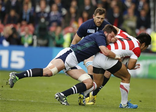 Scotland's Ryan Wilson tackles Japan's Shota Horie during the Rugby World Cup Pool B match between Scotland and Japan at Kingsholm Gloucester England Wednesday Sept. 23 2015