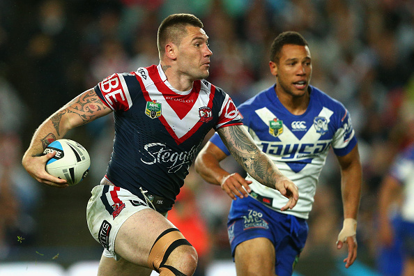 Shaun Kenny Dowall runs the ball up against the Bulldogs