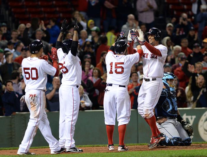 BOSTON MA- SEPTEMBER 21 Xander Bogaerts #2 of the Boston Red Sox slaps high fives after a grand slam to retake the lead in the eighth inning against the Tampa Bay Rays at Fenway Park