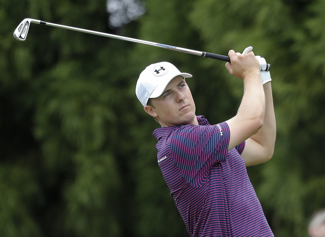 Jordan Spieth hits from the tee on the second hole during the second round of the Tour Championship golf tournament at East Lake Club Friday Sept. 25 2015 in Atlanta. Henrik Stenson examines his ball as he prepares to putt