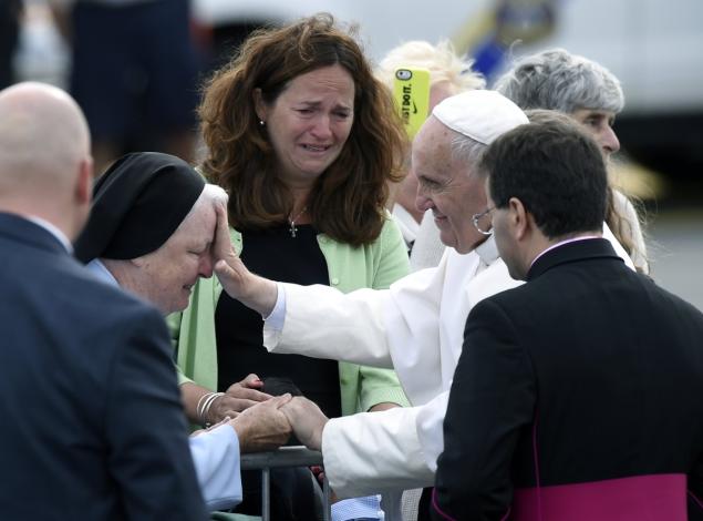 Pope Francis stops to meet people after arriving at Philadelphia International Airport