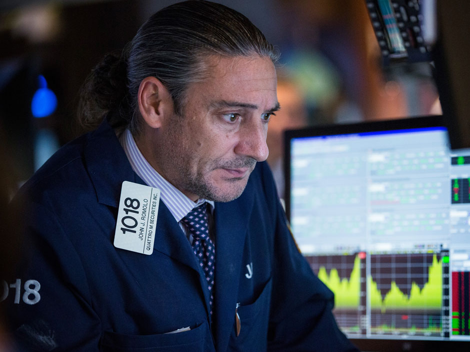 A trader works on the floor of the New York Stock Exchange. North American stocks were positive in Thursday trading