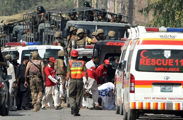 AFP  A Majeed Soldiers arrive to take position as volunteers move an injured person outside a Pakistan Air Force base after an attack by militants in Peshawar