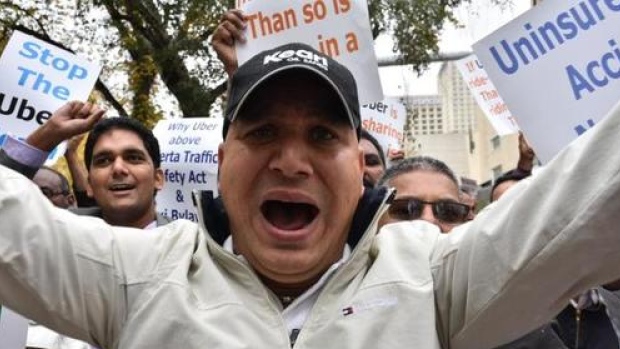 Taxi drivers honked horns and chanted 'shame shame shame&#39 at the Uber supporters who were holding a rally in front of Edmonton city hall Wednesday