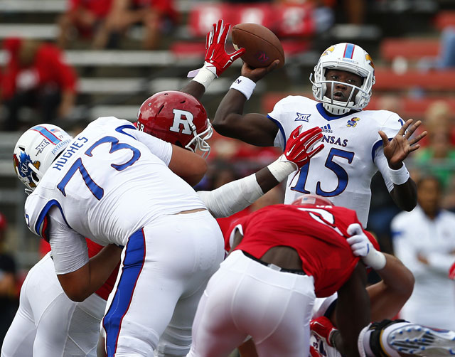 Kansas quarterback Deondre Ford throws under pressure against Rutgers during the first quarter of an NCAA college football game Saturday Sept. 27 2015 in Piscataway N.J. Rutgers won 27-14