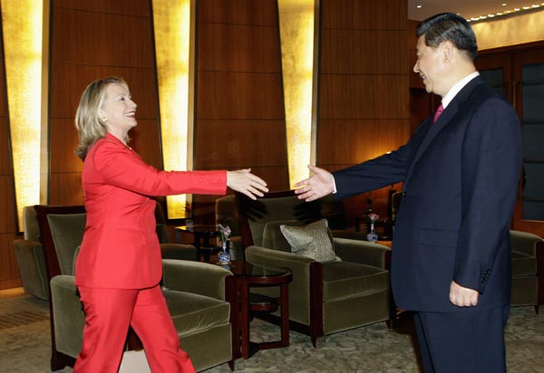 Then Secretary of State Hillary Clinton meets China's then Vice President Xi Jinping in Beijing