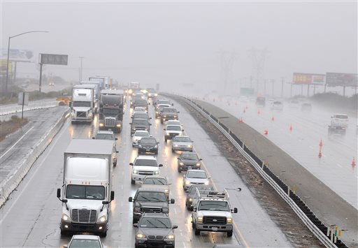 Traffic is slowed from the rain at the Cajon Pass and the Interstate 15 near Hesperia Calif. on Tuesday Sept. 15 2015. A record-breaking storm slammed parched Southern California on Tuesday sending rainfall gushing down roadways and turning the mornin