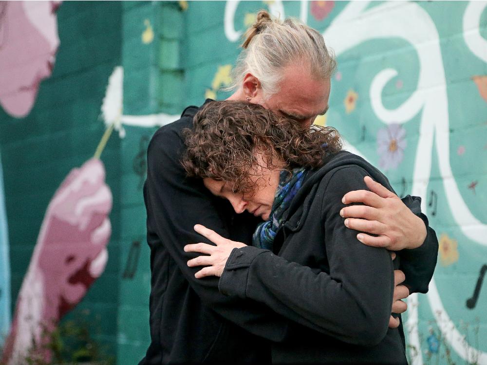 Robert Van Vlaenderen consoles his partner Natalie Robinson- who was a friend of one of the victims Anastasia Kuzyk