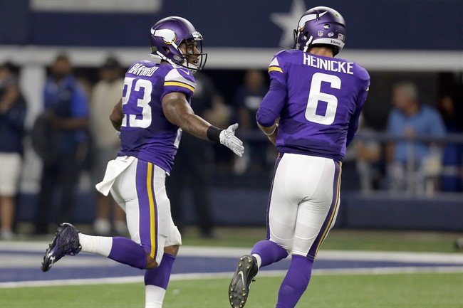 Minnesota Vikings running back Joe Banyard and quarterback Taylor Heinicke celebrate their touchdown against the Dallas Cowboys during the second half of a preseason NFL football game Saturday Aug. 29 2015 in Arlington Texas. (AP