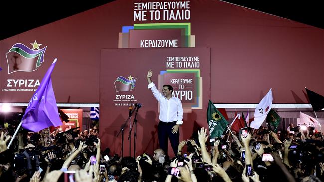 Leader of the Greek Syriza party Alexis Tsipras speaks to supporters as he arrives at the main party's election headquarters in central Athens