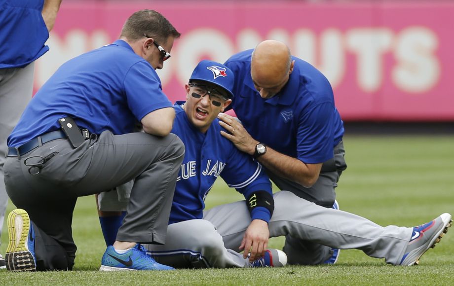 Toronto Blue Jays staff tend to Toronto Blue Jays shortstop Troy Tulowitzki center after he collided with Blue Jays center fielder Kevin Pillar fielding a fly ball in the second inning of a baseball game at Yankee Stadium in New York Saturday Sept. 12