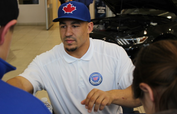 Tyrone Crawford of the Dallas Cowboys signs autographs at Performance Ford in Windsor