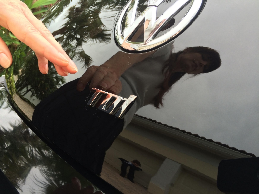 Lisa Lowrance points to the TDI insignia on the back of her Beetle that means it is part of the class of cars that was equipped with technology to cheat emissions tests