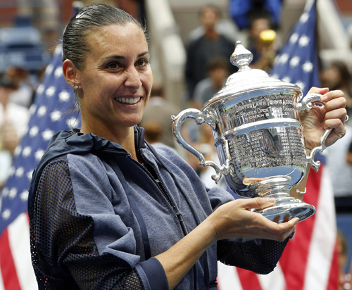 Flavia Pennetta of Italy holds up the championship trophy after beating Roberta Vinci of Italy in the women's championship match of the U.S. Open tennis tournament Saturday Sept. 12 2015 in New York