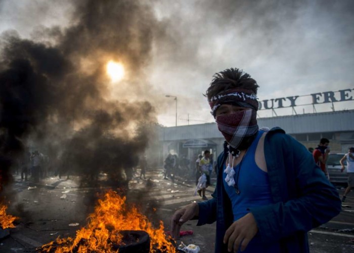 Migrants demonstrate at the border crossing into Hungary near Horgos Serbia Wednesday Sept. 16 2015. The border crossing was closed by the Hungarian police after the Hungarian government declared a state of crisis due to mass migration meaning speci