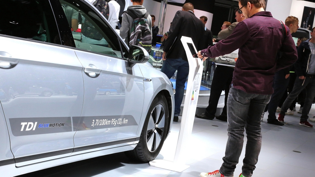 Visitors look at Volkswagen cars at the 2015 IAA Frankfurt Auto Show in Germany Monday. Volkswagen CEO Martin Winterkorn has apologized to customers over a scandal involving emissions in its diesel cars