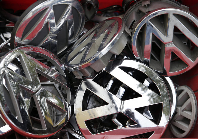 Volkswagen ornaments sit in a box in a scrap yard in Berlin Germany Wednesday Sept. 23 2015. The revelation that Volkswagen rigged diesel-powered cars to emit lower emissions during EPA tests is particularly stunning since Volkswagen has long projecte