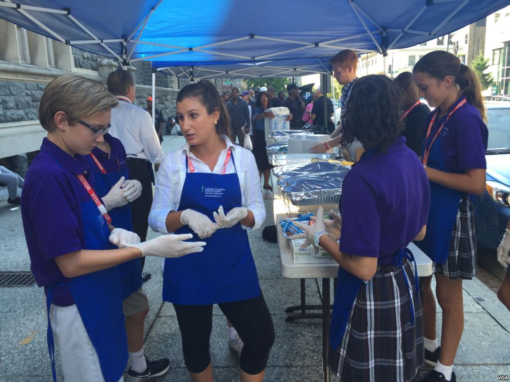 Volunteers with Catholic Charities distribute food in Washington