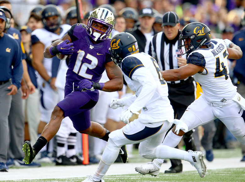 Washington tailback Dwayne Washington takes it upfield for 14 yards against California