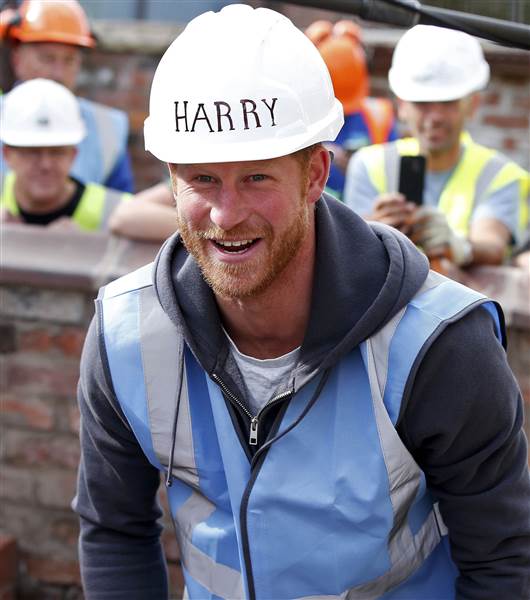 Britain's Prince William paints a wall during a visit to Manchester