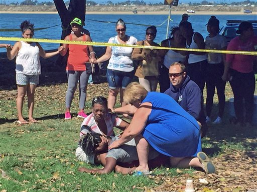 Daniesha Hilaire collapses in the arms of a relative after the body of her 4-year-old son Wesley Hilaire was recovered from the waters of Mission Bay Sunday Sept. 13 2015 in San Diego as relatives and others form an impromptu prayer circle. KNSD-TV