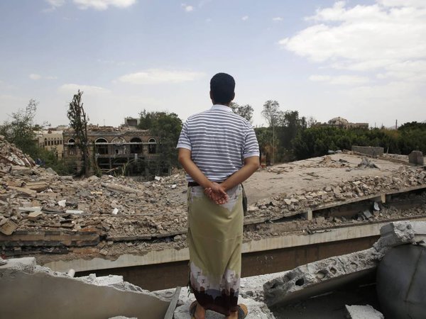 A man looks at the Houthi-controlled headquarters of the Yemeni army destroyed by Saudi-led airstrikes in Sanaa Yemen Wednesday Sept. 16 2015. The Shiite rebels known as the Houthis still control Sanaa and are resisting a push by pro-government force