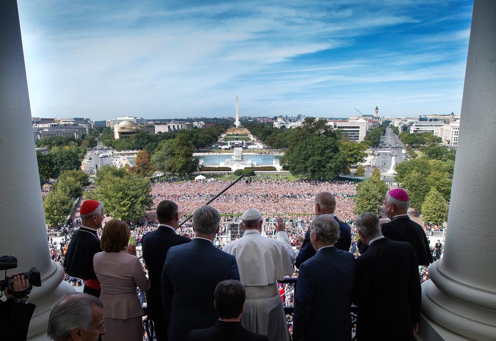 Pope Francis accompanied by members of Congress waves to the crowd from the Speakers Balcony on Capitol Hill in Washington Thursday Sept. 24 2015 after addressing a joint meeting of Congress inside. Doug Mills  The New York Times via AP Pool))- D