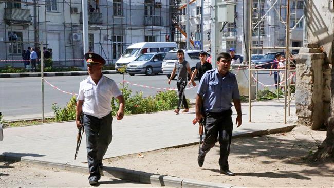 Police officers secure an area in the capital of Tajikistan Dushanbe where several officers of the Tajik Interior Ministry special forces and a traffic policeman were reportedly shot dead earlier on Friday