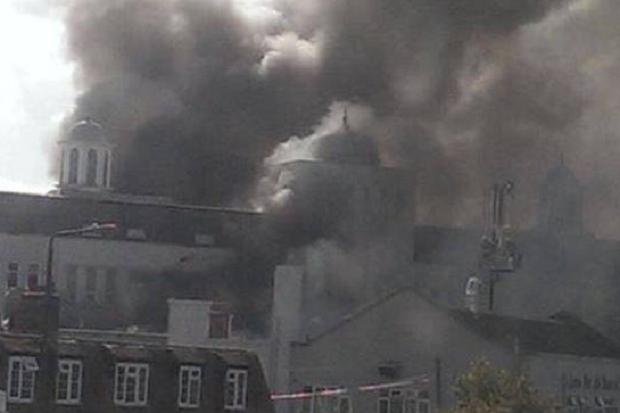 Around 60 firefighters are tackling the blaze at the mosque in Morden pic Caters