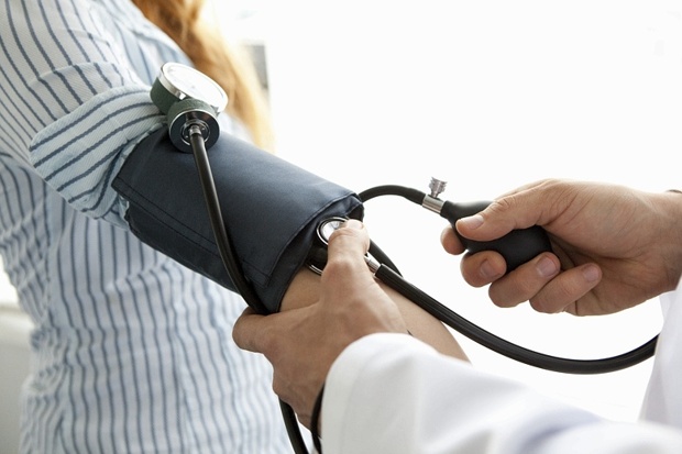 Doctor taking a patient's blood pressure