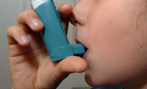 A child takes an asthma inhaler