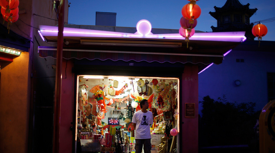 A man stands in a store selling lanterns in Chinatown in Los Angeles California