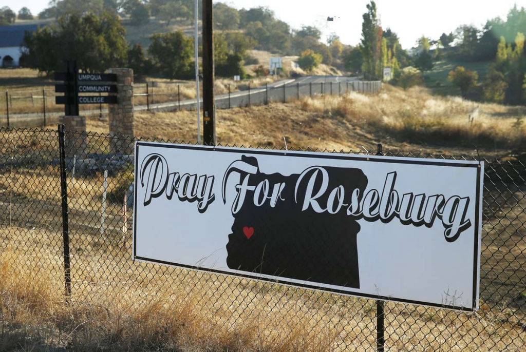 A sign hangs on a fence near the road leading to the Umpqua Community College campus Friday Oct. 2 2015 in Roseburg Oregon