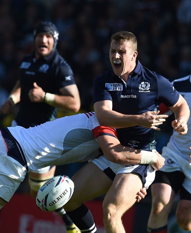 AFP  Getty
Scotland's centre Mark Bennett is tackled by US flanker Al Mc Farland in the second group match