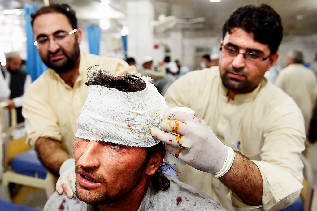 Quake1027 Pakistani paramedics treat a man injured in an earthquake at a hospital Monday in Peshawar. At least 17 people including eight children were killed in Pakistan when a 7.5-magnitude quake struck in Afghanistan officials said